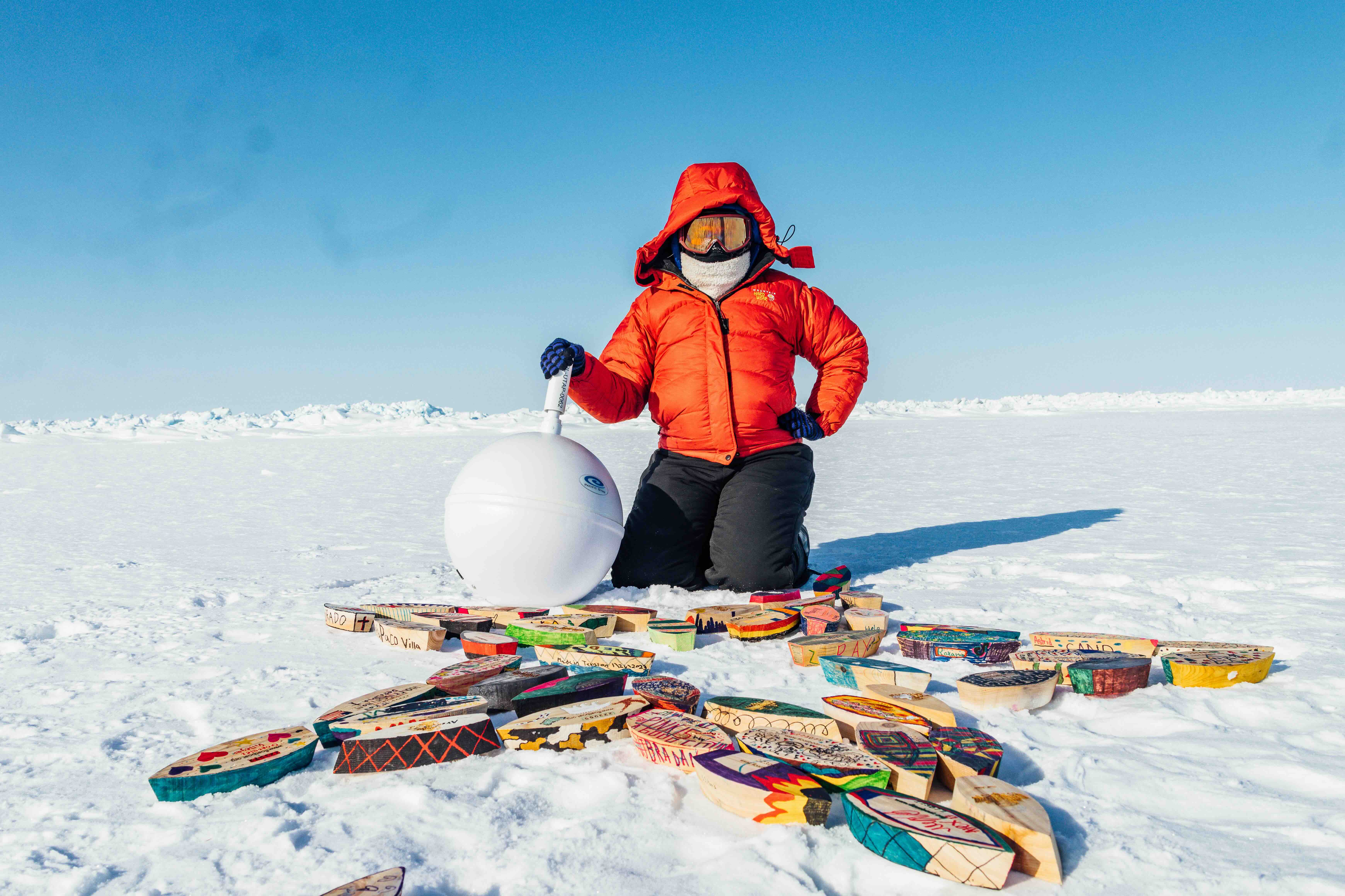 Sarah Johnson, of Wild Rose Education in Carbondale deploying Float Your Boat boats alongside a parent Arctic buoy on the sea ice of the Beaufort Sea north of Alaska.