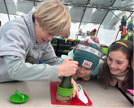 Fourth graders creating “zoodles” with a veggie spiralizer.