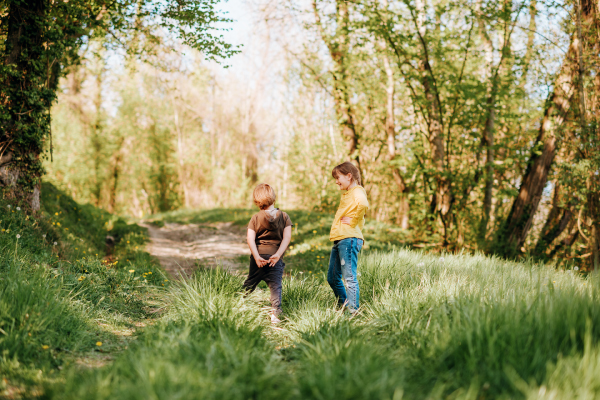 Two-funny-kids-playing-together-in-spring-forest-600x400